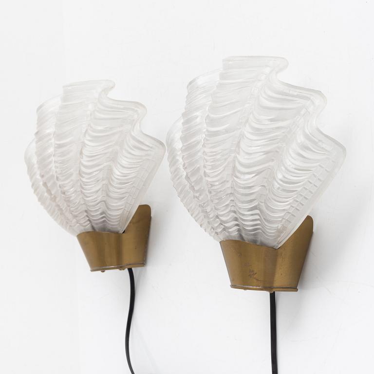 A pair of glass and brass 'Coquille' wall lights from Asea, 1940's.
