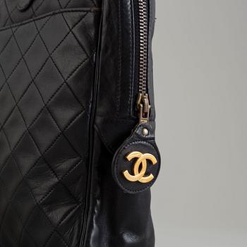 a CHANEL black leather bag.