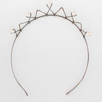 A silver tiara set with pearls.