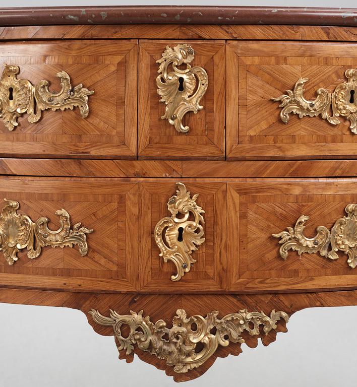 A Louis XV kingwood parquetry and ormolu-mounted commode in the manner of Jacques-Philippe Carel (Paris, 1723-1760).