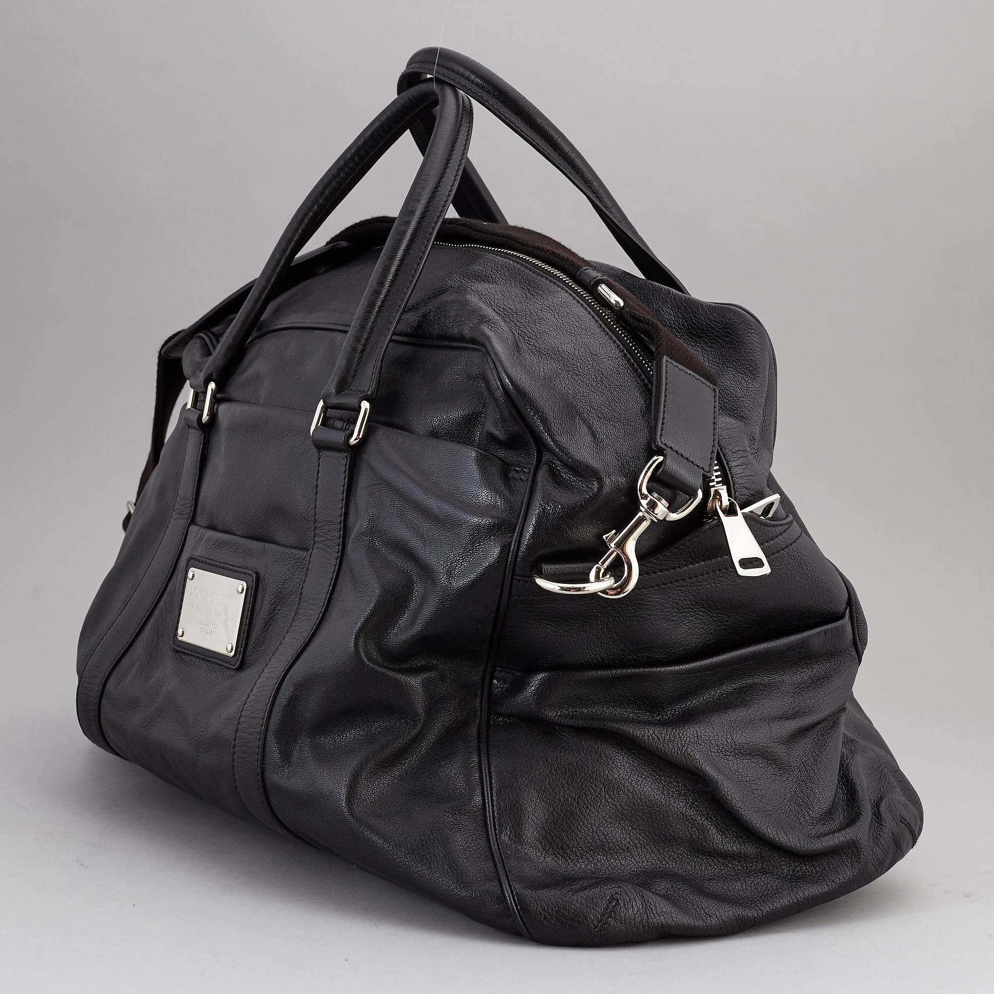 DOLCE GABBANA a black leather weekend bag 2009. Bukowskis