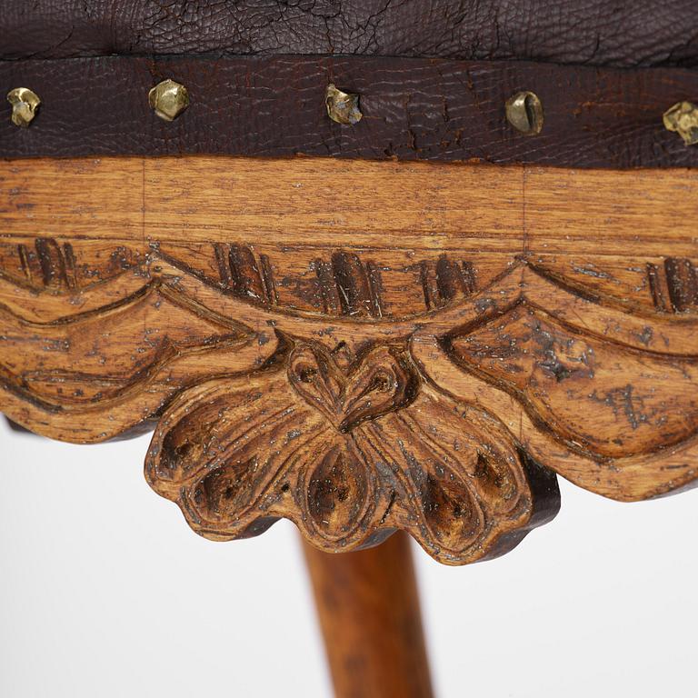 A pair of carved stools in the manner of Jonas Granberg, Jämtland, Sweden, mid 18th century.