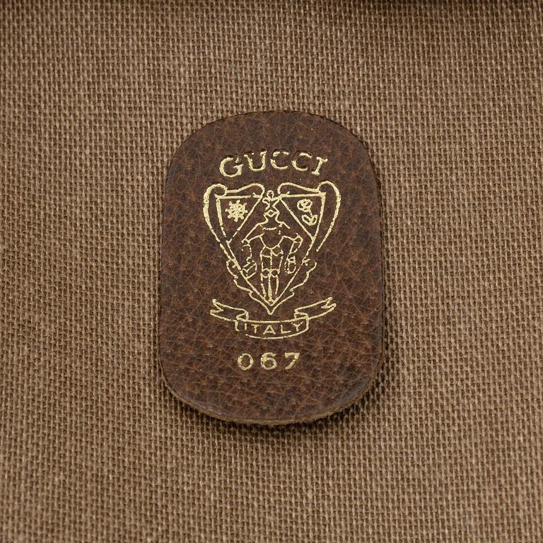 Gucci, a canvas weekend bag.