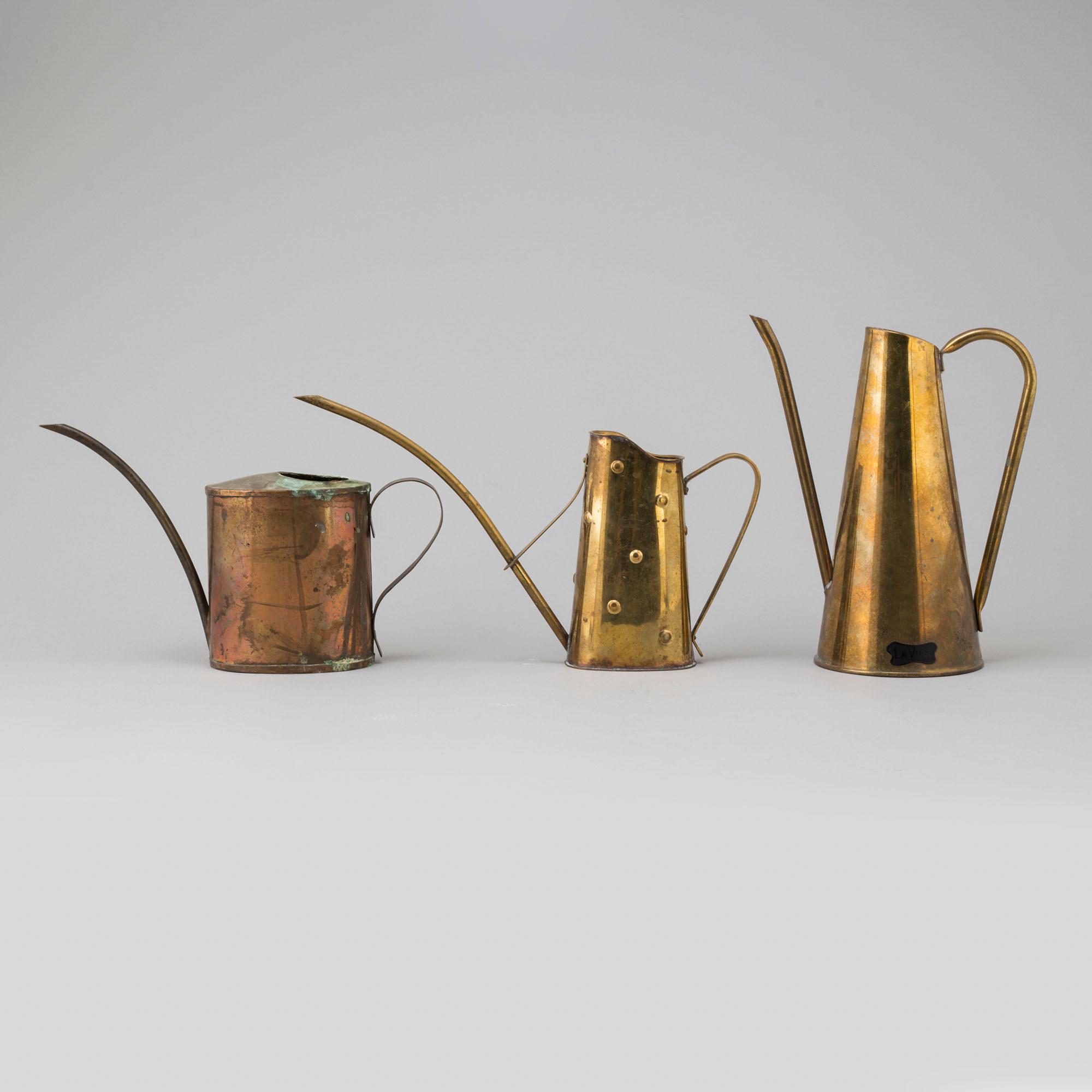 Eight 19th and 20th century copper and brass watering cans.