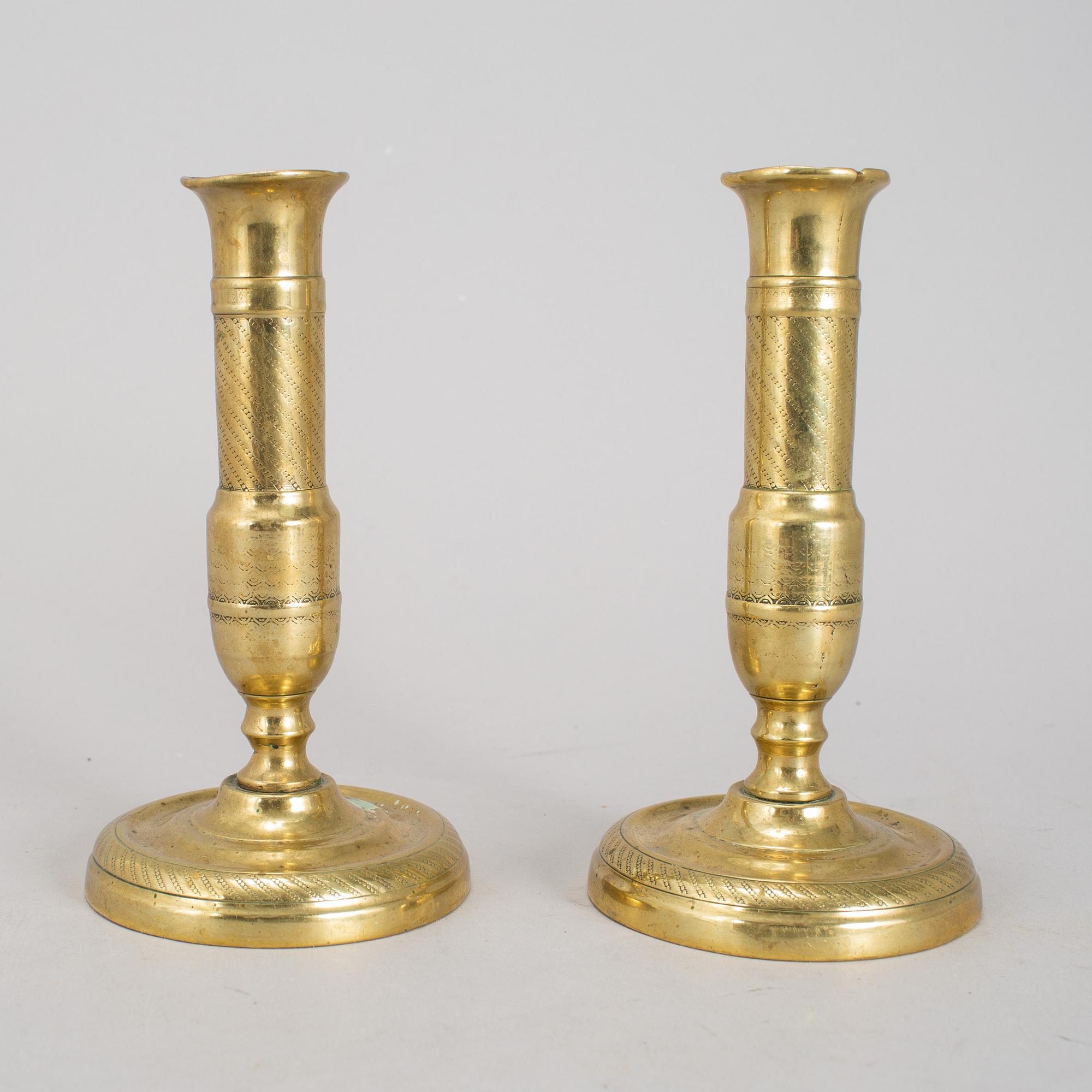 A 19th Century pair of brass candlesticks.