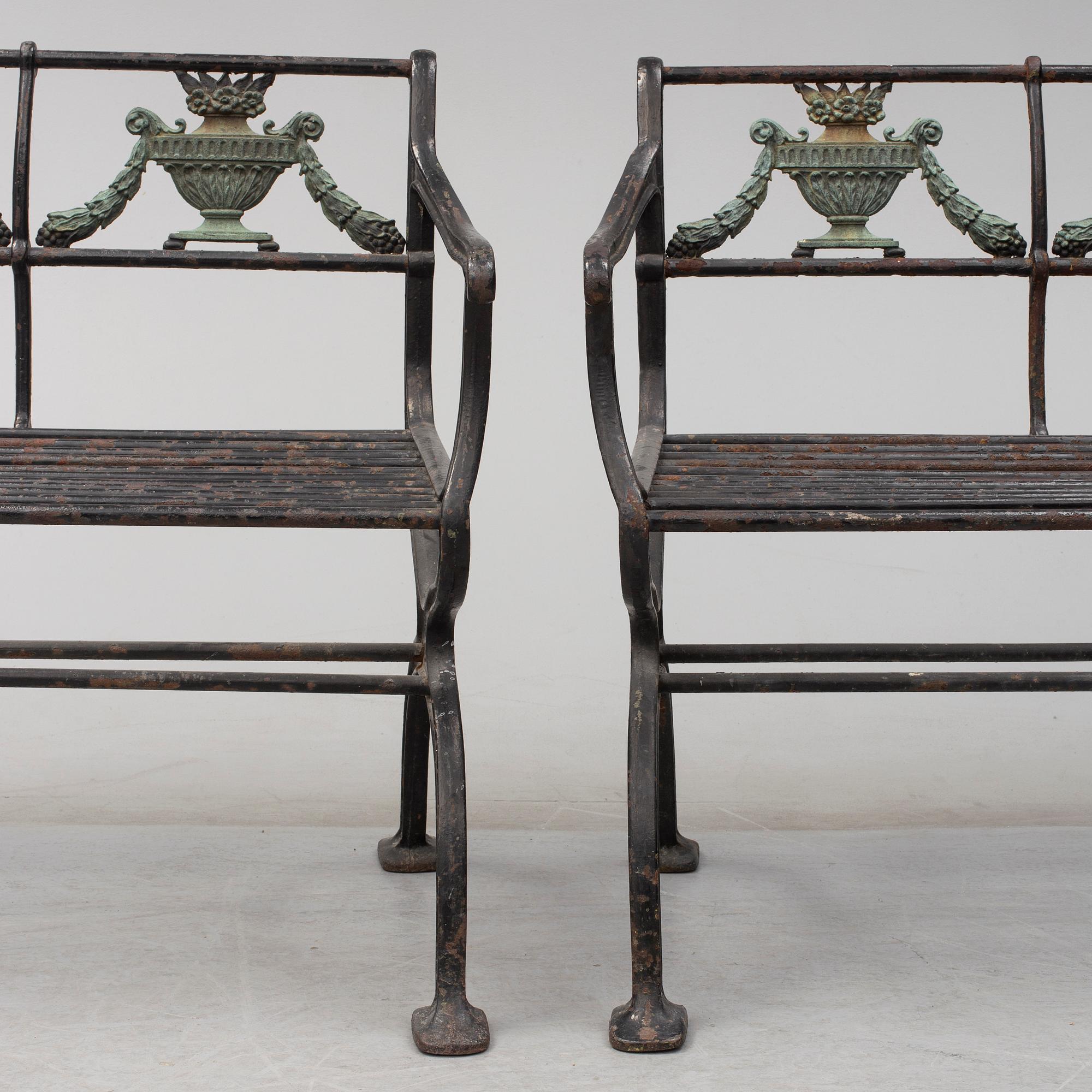 GARDEN SOFAS, a pair, cast iron, empire style, late 19th century.