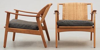 A pair of Danish teak and ratten armchairs, attributed, 1950's-60's.