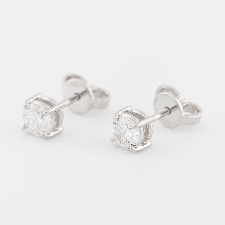 A pair of brilliant cut diamond earrings.