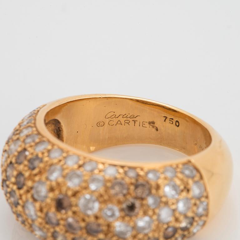 A Cartier "Sauvage" ring in 18K gold set with white and brown round brilliant-cut diamonds.