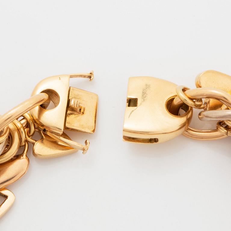 An 18K gold Gaudy bracelet with heart shaped charms.