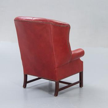 An English leather wing back chair later part of the 20th century.