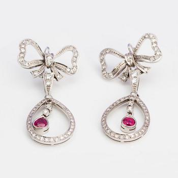 A pair of ruby and single-cut diamond earrings in the shape of bows. .