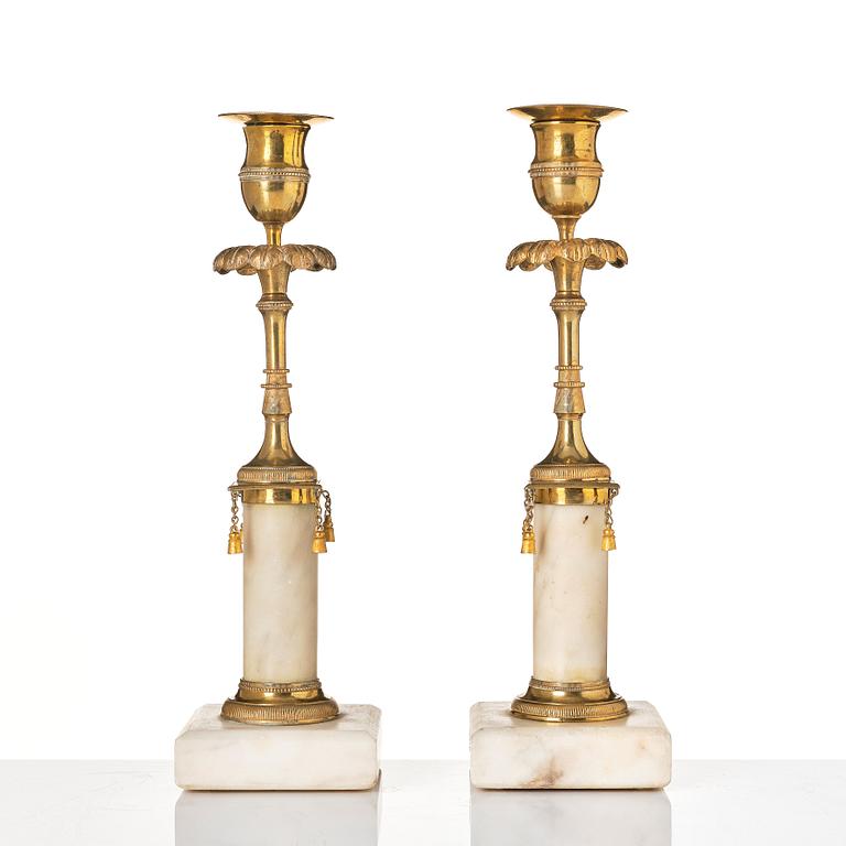 A pair of late Gustavian marble and bronze candlesticks.