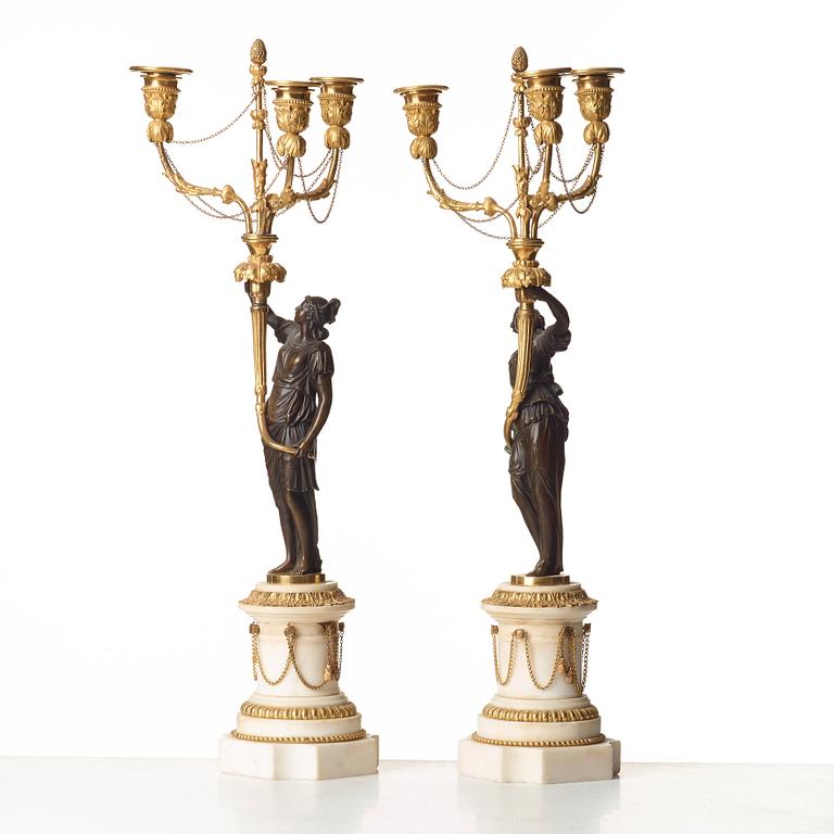 A pair of Louis XVI 18th century gilt and patinated bronze and marble three-light candelabra.