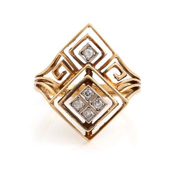 An Ilias Lalaounis ring in 18K gold set with eight-cut diamonds.