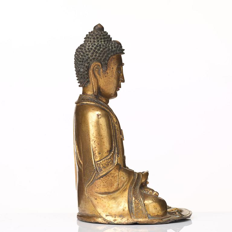 A gilt bronze figure of Amithaba Buddha, Ming dynasty (1368-1644).