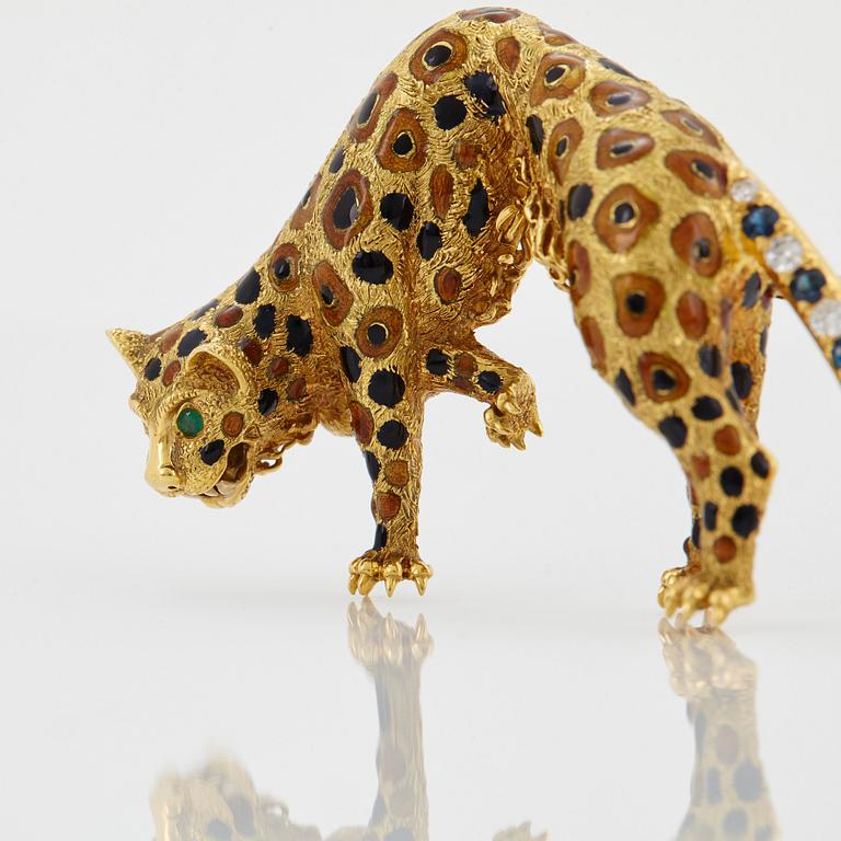 An 18K gold panther brooch set with round brilliant-cut diamonds, sapphires and emeralds.