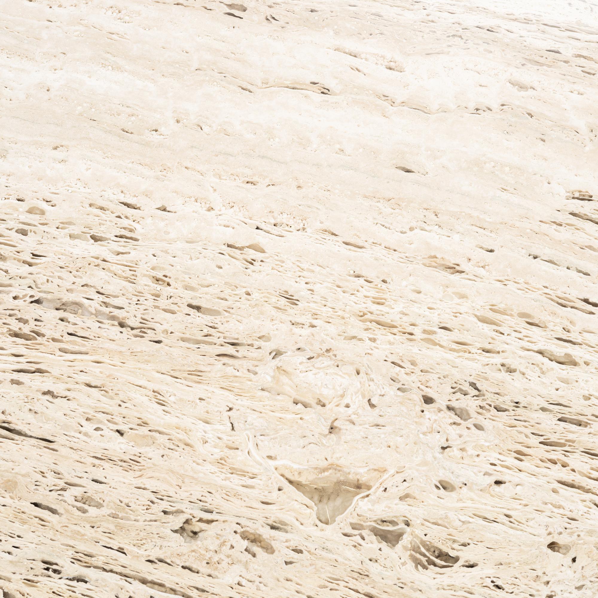 A travertine  'Epic Dining Table' from Gubi.