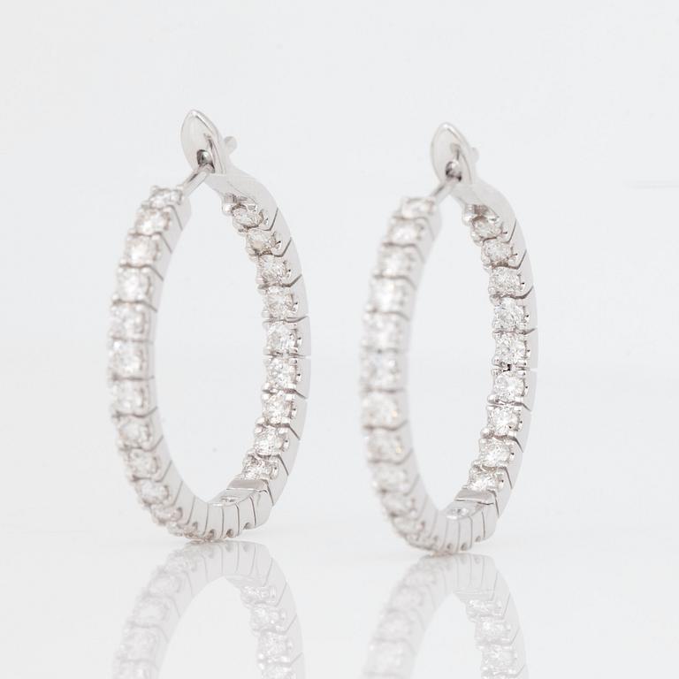 A pair of diamond, 2.303 cts according to engraving, loop earrings.