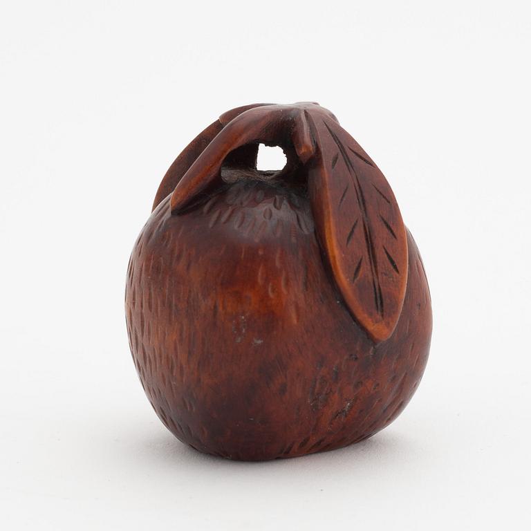 A Japanese carved corozo nut bird feeder, second half of the 19th Century.