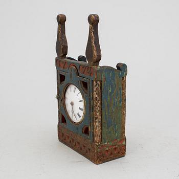 A carved and painted folk art pocket watch case dated 1774.