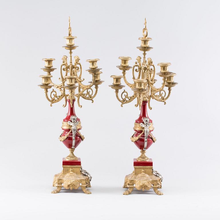 A Franz Hermle mantel clock and a pair of chandelabras. mid/2:nd half of the 20th century.