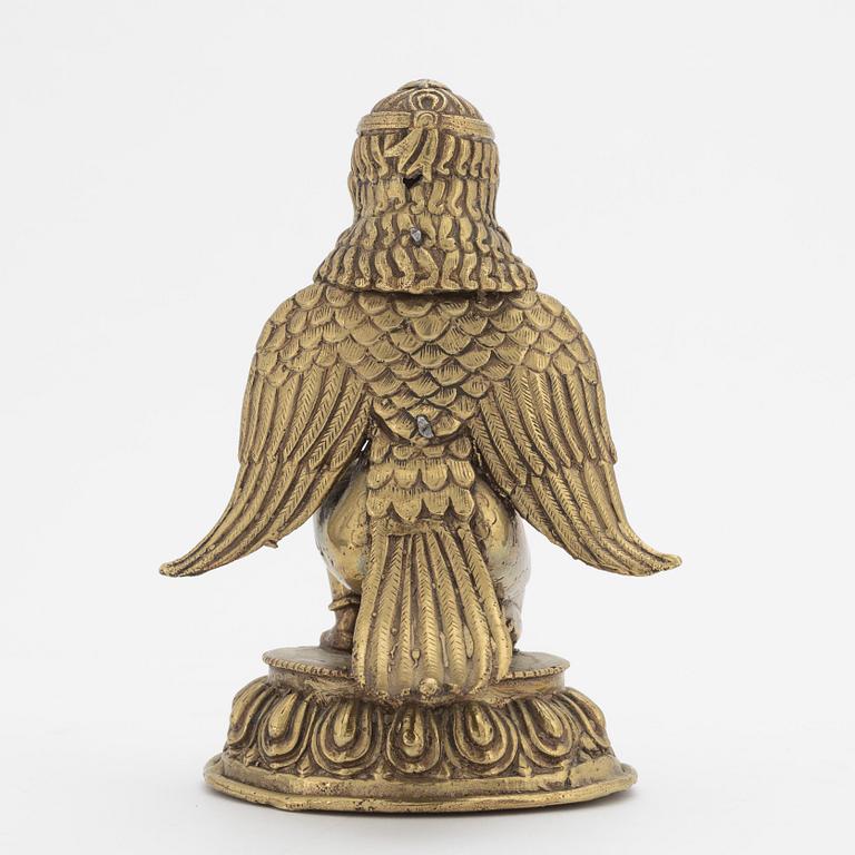 A copper alloy figure of bewinged dignitary, Nepal, 20th Century.