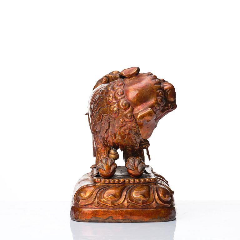 A cold gilt and lacquered copper alloy sculpture of a buddhist lion, Tibeto-Chinese/Mongolian, 18th Century.