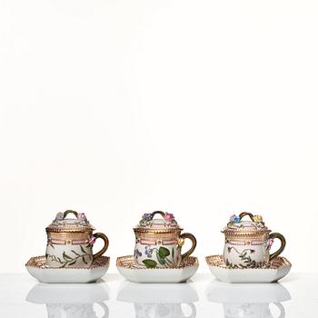 A set of 12 Royal Copenhagen 'Flora Danica' custard cups with covers and stands, Denmark, 20th Century.