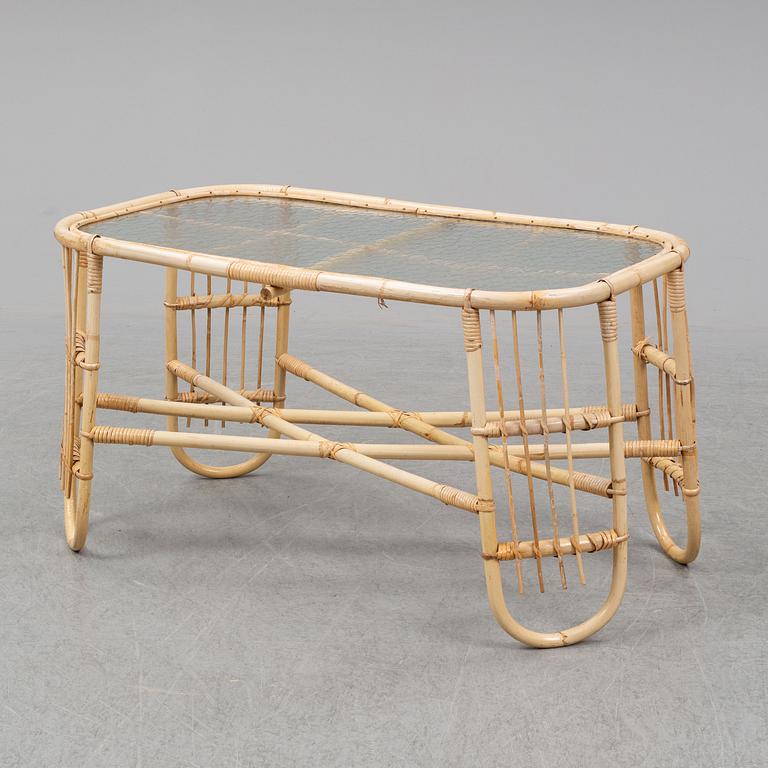 A rattan and glass table and a rattan sofa, second half of the 20th century.