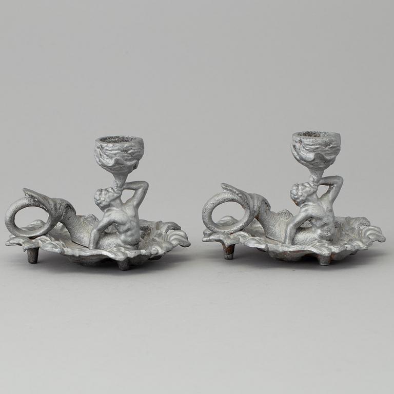 A pair of cast iron candlesticks, marked Verlag bei, A. Meves, Berlin, late 20th century.