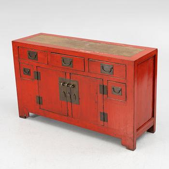 A Chinese red lacquered cabinet, 20th century.