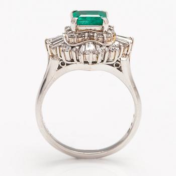 A platinum ring with a ca. 1.15 ct emerald and ca. 1.00 cts of diamonds in total.