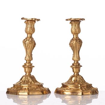 A pair of French Louis XV mid 18th century gilt bronze candlesticks.