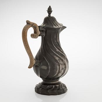 A mid 18th century rococo pewter jug.