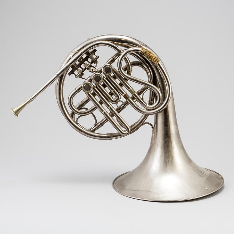 A metal french horn, probably 1936.