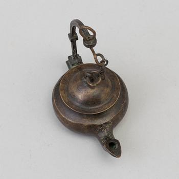 An 18th century bronze oil lamp.