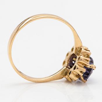 An 18K gold ring with a tanzanite and yellow sapphires.
