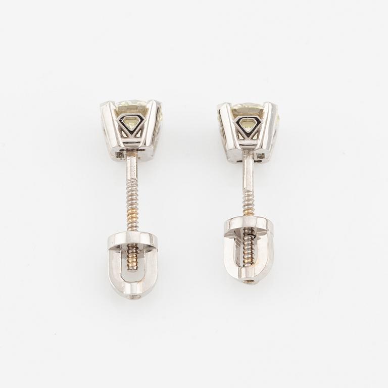 A pair of 18K gold earrings with round brilliant-cut diamonds.