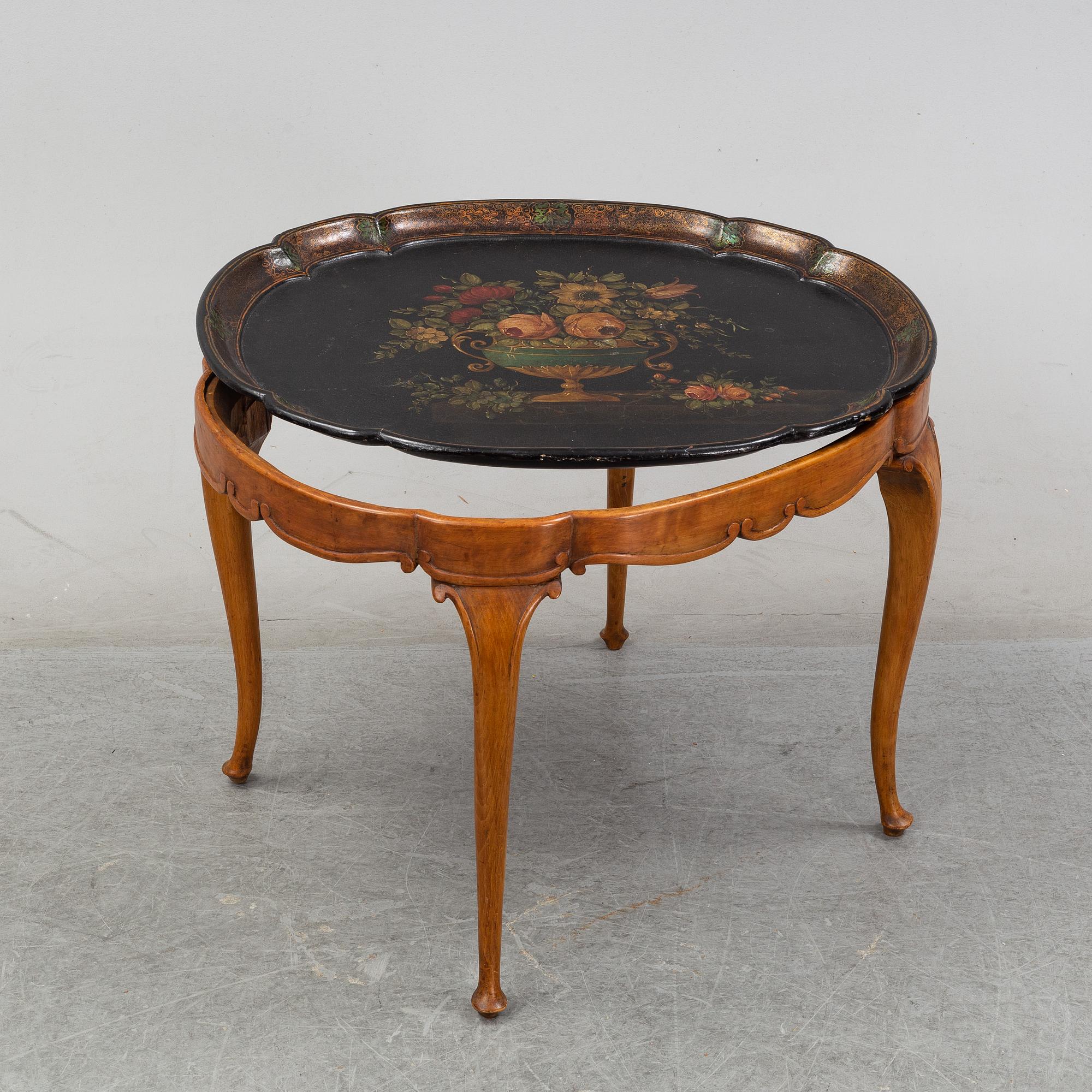 A rococo style side table with a loose tray.