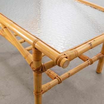 A set of ratten furniture, late 20th century; sofa, armchairs and a lounge table.