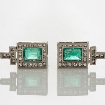 A pair of emerald earrings set with eight-cut diamonds.