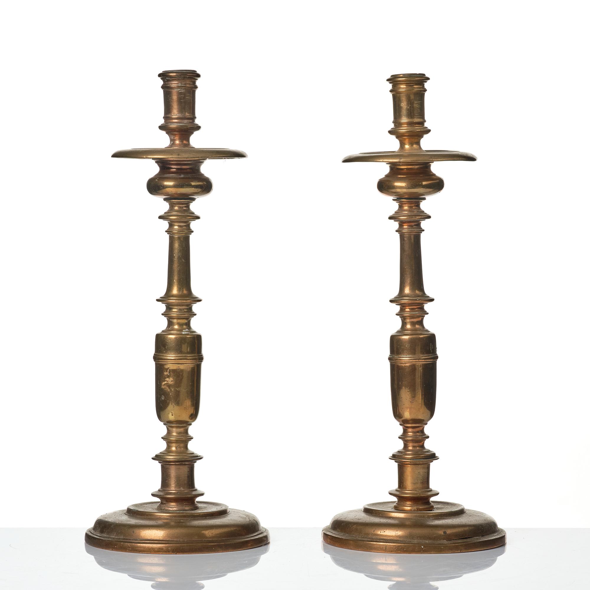 A pair of baroque brass candlesticks, 18th century.
