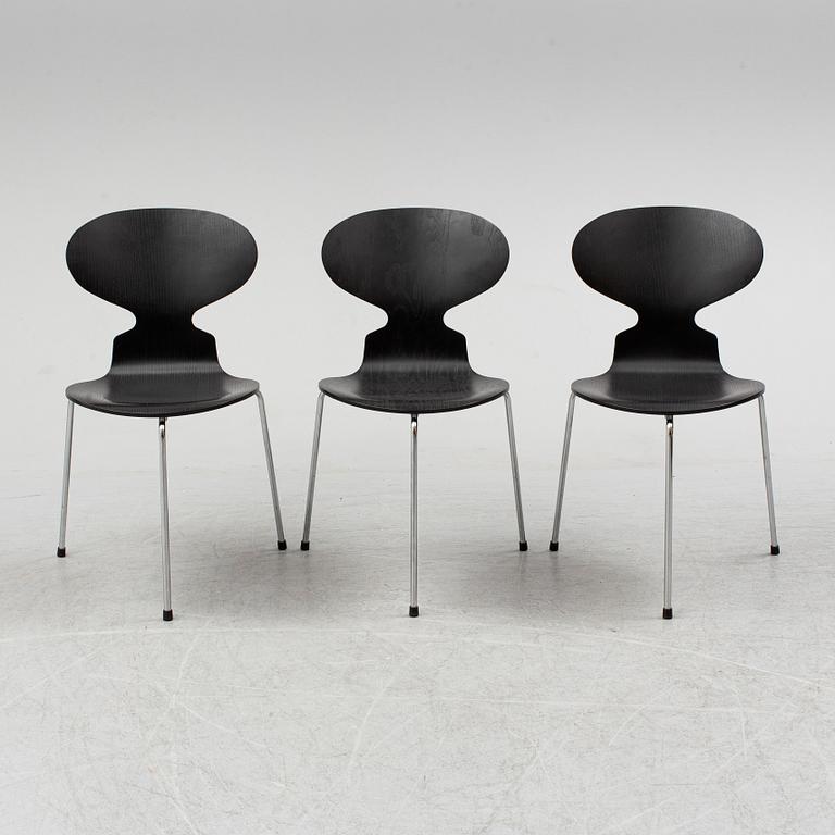 An Arne Jacobsen "Centenary Package" comprising three "Ant Chairs" and an eggshaped table, Fritz Hansen, Denmark.