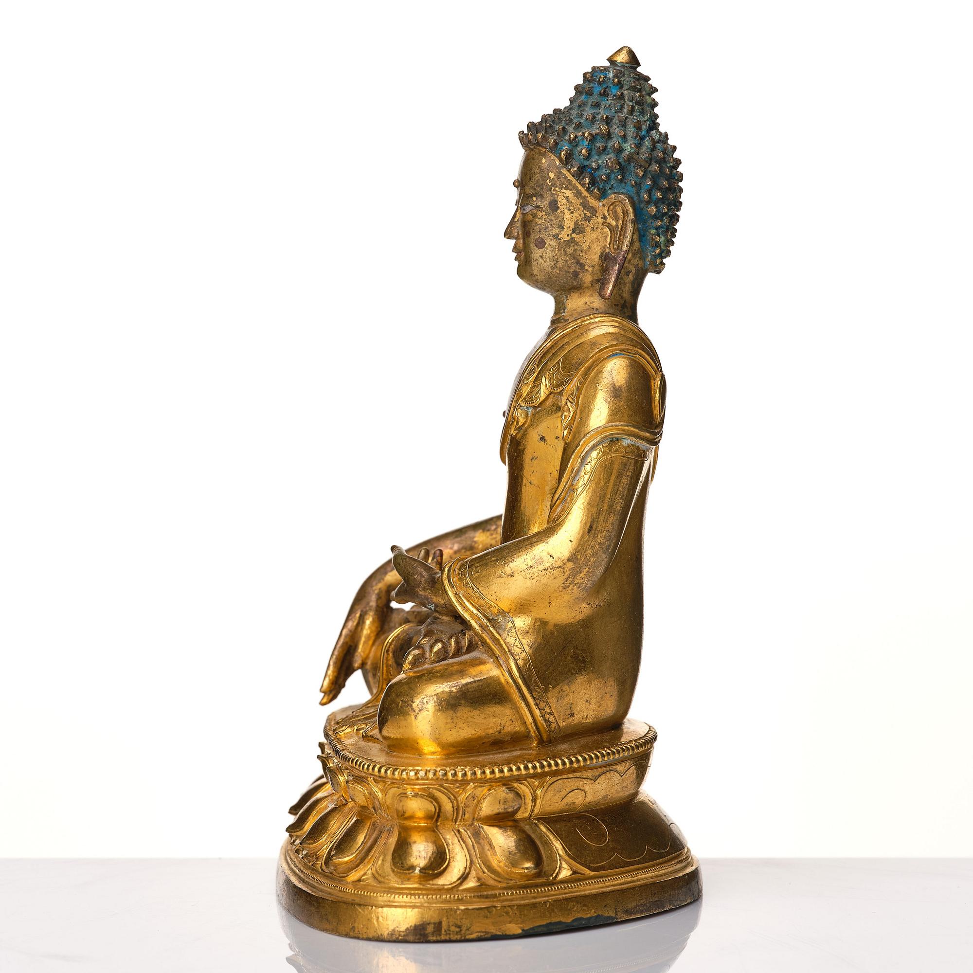 A Tibeto Chinese style gilt copper alloy figure of Buddha.