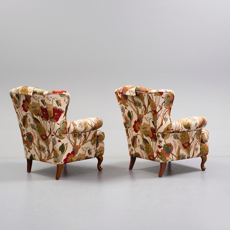 A pair of 20 th century arm chairs.