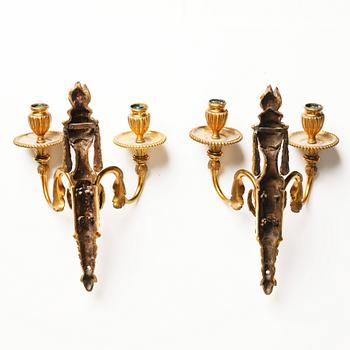 A pair of Louis XVI late 18th century gilded bronze two-light wall-lights.