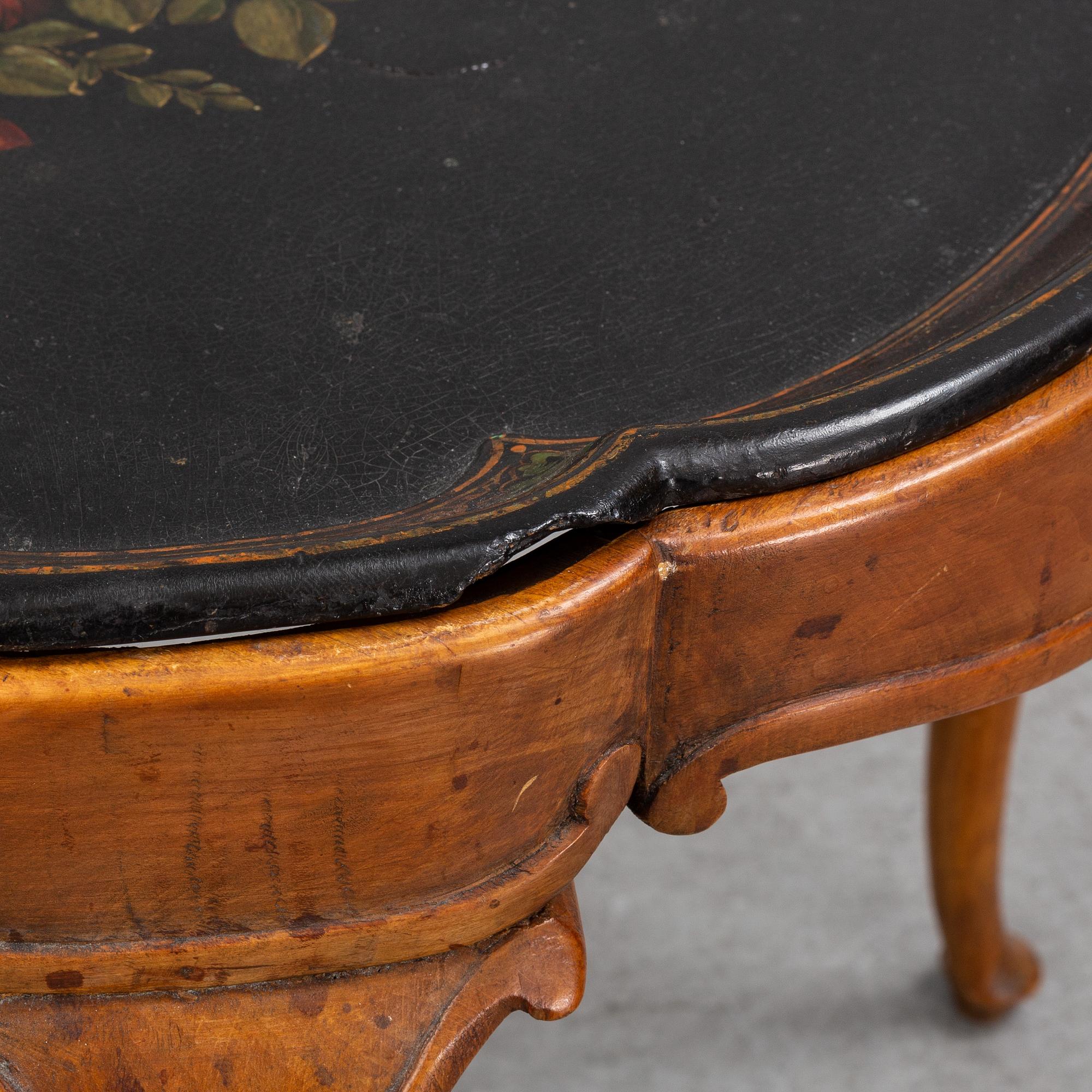 A rococo style side table with a loose tray.