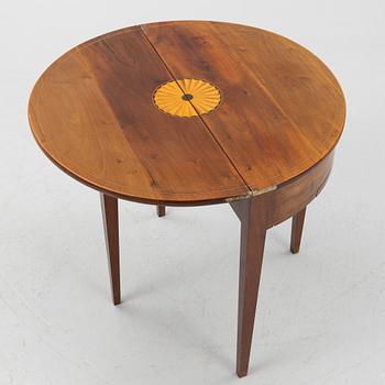 A crescent shaped table, around 1900.
