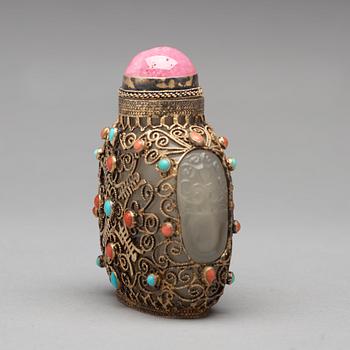 Three nephrite and agathe snuff bottles with stoppers, China and Tibet, late 19th Century.